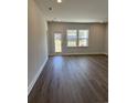 Spacious living room with wood flooring, neutral walls, and natural light at 1312 Winding Creek Way, Myrtle Beach, SC 29588