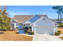 White house with gray roof, two-car garage, and neat landscaping at 1377 Southwood Dr., Myrtle Beach, SC 29575