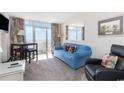 Bright living room with ocean view, comfy seating, and a small dining table at 161 Seawatch Dr. # 1108, Myrtle Beach, SC 29572