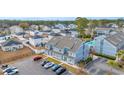 Aerial view showing a townhome with ample parking and surrounding houses at 1881 Colony Dr. # 7D, Surfside Beach, SC 29575