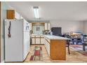 Galley kitchen with white appliances and wood cabinets at 1881 Colony Dr. # 7D, Surfside Beach, SC 29575