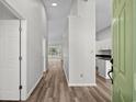 Light and airy entryway with wood-look floors, leading to the living area at 2307 Blackbird Ct., Murrells Inlet, SC 29576