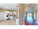 Modern kitchen with white cabinets, stainless steel appliances, granite countertops, and a breakfast bar overlooking the living area at 257 Venice Way # H 204, Myrtle Beach, SC 29577