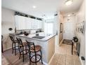 Kitchen with breakfast bar, white cabinets, and view to entry at 270 Connemara Dr. # C, Myrtle Beach, SC 29579