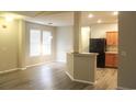 Bright dining room with hardwood floors and kitchen view at 306 Kiskadee Loop # A, Conway, SC 29527