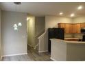 Modern kitchen with wood cabinets, black appliances, and breakfast bar at 306 Kiskadee Loop # A, Conway, SC 29527