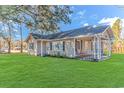 Ranch style home with a large yard and front porch at 3703 Green Sea Rd., Green Sea, SC 29545