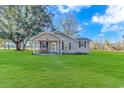 Charming house with a spacious green lawn and front porch at 3703 Green Sea Rd., Green Sea, SC 29545