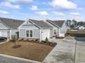 Gray house with a gray roof and a landscaped yard at 4040 Taranto Loop # D, Myrtle Beach, SC 29579