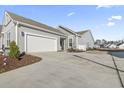 Gray siding house with a white garage door and driveway at 4040 Taranto Loop # D, Myrtle Beach, SC 29579