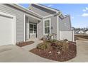 Gray house with a white door and well-manicured front yard at 4040 Taranto Loop # D, Myrtle Beach, SC 29579