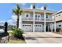 Two-story house with double garage and a palm tree at 406 Harbour View Dr., Myrtle Beach, SC 29579