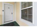 Condo building entry with white door and window, showing keyless entry at 4872 Dahila Ct. # 301, Myrtle Beach, SC 29577