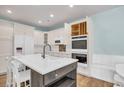 Modern kitchen with white cabinets, quartz island, and double oven at 503 Waltham Forest Dr. # 1004, Murrells Inlet, SC 29576