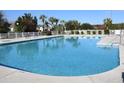 Community swimming pool with surrounding patio and palm trees at 503 Waltham Forest Dr. # 1004, Murrells Inlet, SC 29576