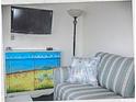 Living room with sofa and beach-themed cabinet at 5905 S Kings Highway # 2106-C, Myrtle Beach, SC 29575