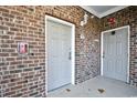 Brick building with two gray doors and a fire alarm at 6203 Catalina Dr. # 1814, North Myrtle Beach, SC 29582