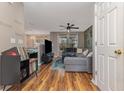 Living room boasts hardwood floors, L-shaped sofa, and large TV at 629 Riverward Dr. # 629, Myrtle Beach, SC 29588