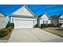 Two-car garage with front yard landscaping at 6425 Cascata Dr., Myrtle Beach, SC 29572