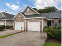 Brick front and two-car garage with landscaping at 663 Pinehurst Dr. # 93C, Pawleys Island, SC 29585