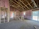 Open concept living room featuring unfinished walls, bare concrete floors and natural light at 8183 Kerl Rd., Conway, SC 29526