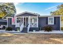 Gray house with white trim and a welcoming porch at 1005 S Marlin Circle, Murrells Inlet, SC 29576