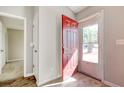 Bright entryway with red door, hardwood floor, and view of backyard at 104 Osprey Cove Loop, Myrtle Beach, SC 29588