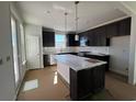 Stylish kitchen featuring black cabinets, a white countertop, and a center island with pendant lighting at 1273 Lady Bird Way, North Myrtle Beach, SC 29582