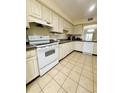 White kitchen with ample cabinetry and tiled floors at 1650 Deercreek Rd., Surfside Beach, SC 29575