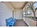 Relaxing front porch with blue bench overlooking a waterway at 19 Cattail Ct. # 2B, Pawleys Island, SC 29585