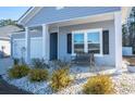 Front porch with a bench and white columns at 2024 Willow Run Dr., Little River, SC 29566