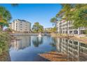 Community pond view with fountain and reflecting buildings at 209 Hillside Dr. N # 204, North Myrtle Beach, SC 29582