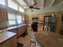 Bright kitchen with wood cabinets, stainless steel appliances, and an island at 2228 Oyster Cove, Murrells Inlet, SC 29576