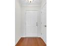 Simple entryway with hardwood floors and white door at 306 Andorra St., Longs, SC 29568