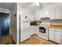 White kitchen with appliances and wood flooring at 3610 S Ocean Blvd. # 316, North Myrtle Beach, SC 29582