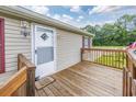 Wooden deck with railing and door leading into the home at 3845 Woodridge Circle, Little River, SC 29566