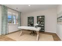 Home office with hardwood floors, built-in shelving, and a desk at 4027 Smokey Dr, Conway, SC 29526