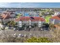 Aerial view of condos and a marina filled with boats, surrounded by green spaces and parking at 4210 Coquina Harbour Dr. # A-16, Little River, SC 29566