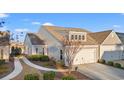 Gray house with two-car garage and landscaped yard at 4451 Livorn Loop # 4451, Myrtle Beach, SC 29579