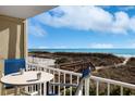 Ocean view balcony with table and chairs at 4605 S Ocean Blvd. # E-1, North Myrtle Beach, SC 29582