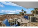 Ocean view balcony with table and chairs at 4605 S Ocean Blvd. # E-1, North Myrtle Beach, SC 29582