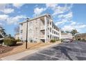 Side view of the building showcasing its brick facade and balconies at 4781 Wild Iris Dr. # 304, Myrtle Beach, SC 29577