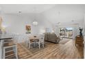 Open concept dining area with a wood table and white chairs at 4894 Luster Leaf Circle # 402, Myrtle Beach, SC 29577