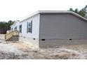 Gray vinyl siding house with brick base and wooden steps at 5225 Hwy 712, Galivants Ferry, SC 29544