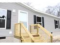 House entrance with wooden steps and gray siding at 5225 Hwy 712, Galivants Ferry, SC 29544