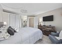Well-lit bedroom featuring a comfortable bed, closet, and dresser with a mounted TV at 5523 N Ocean Blvd. # 1601, Myrtle Beach, SC 29577