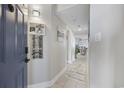 Inviting hallway featuring a blue door, neutral walls and decor leading to living area at 5523 N Ocean Blvd. # 1601, Myrtle Beach, SC 29577