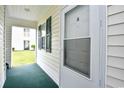 Private entrance with a screen door and green carpeting at 557 White River Dr. # 12A, Myrtle Beach, SC 29579