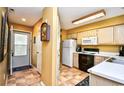 Galley kitchen with light wood cabinets and white appliances at 557 White River Dr. # 12A, Myrtle Beach, SC 29579