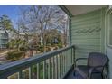 Private balcony overlooking a courtyard with trees and seating at 5905 South Kings Hwy. # 4205, Myrtle Beach, SC 29575